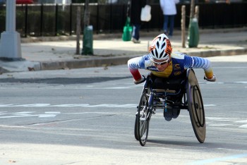 a wheelchair marathoner, mid-push